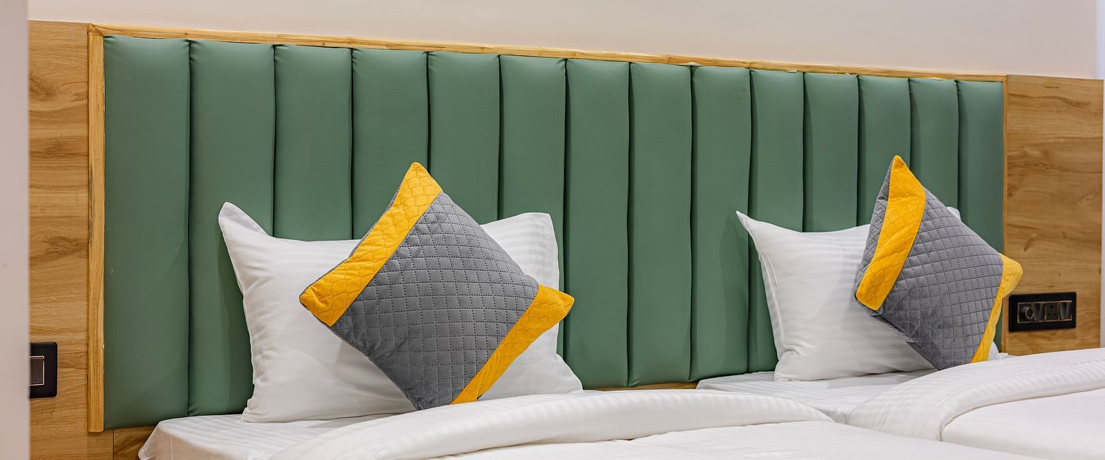 Lemonridge Hotels, KPHB | Close-up of a bed with decorative pillows and a headboard. Comfortable and inviting.